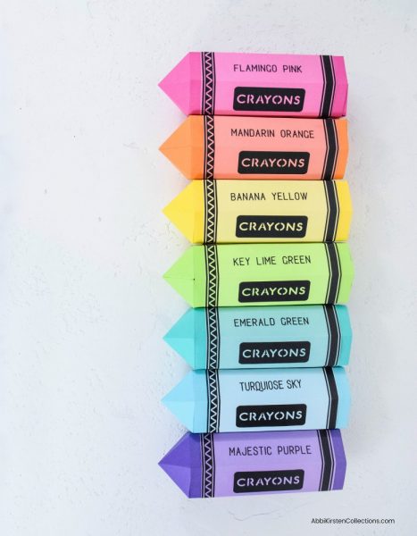 A birds-eye view of paper crayon gift boxes lined up in rainbow formation. If you are looking for the perfect teacher appreciation gift, get your free template here. 