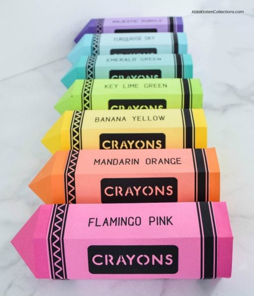 A rainbow display of seven large crayons made from paper and in all the colors of the rainbow. These teacher appreciation gifts are easy to make.