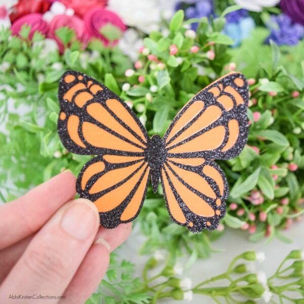 Learn how to make paper butterflies using your Cricut and cardstock with glitter iron-on vinyl. Download free butterfly SVG templates for Cricut. 