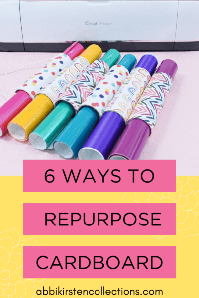 A picture of six rolls of vinyl kept in rolls by decorated upcycled cardboard tubes. The yellow graphic on the bottom says "6 Ways to Repurpose Cardboard."
