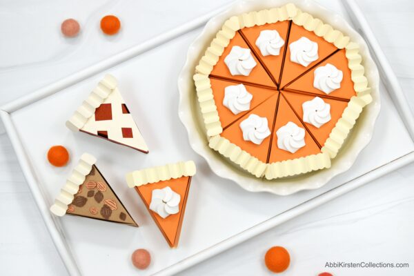 DIY Pumpkin Pie Craft Boxes. Wow, you guests this holiday season with these take-home pie boxes you can make with Cricut! Free SVG files and PDF printables included