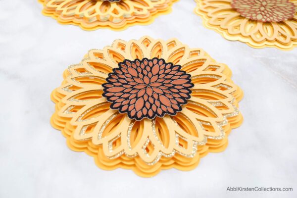 Learn how to make this stunning 3D paper sunflower mandala using your Circut machine and these free paper mandala SGV files.