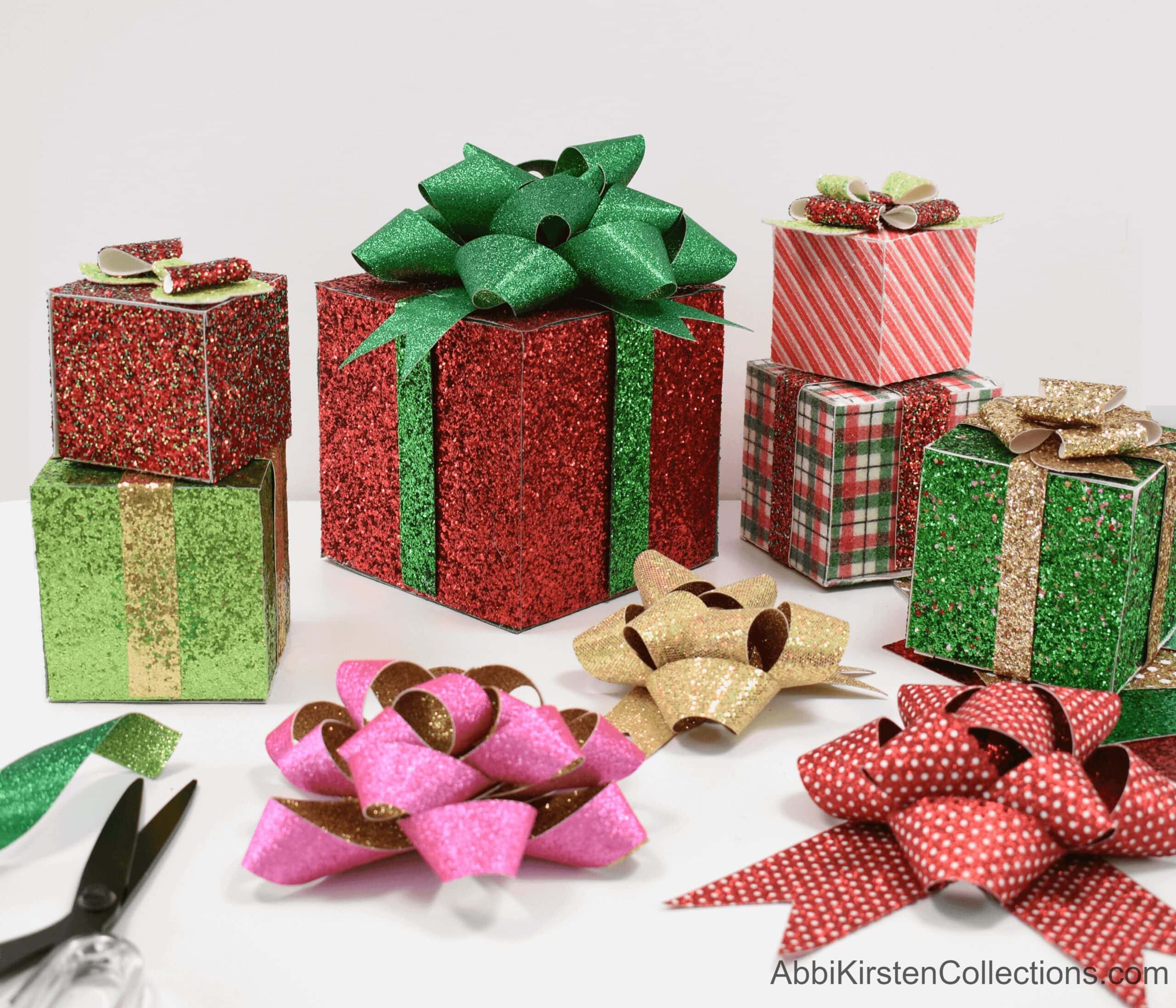 An array of decorative gift boxes and bows of different sizes and colors, all made with faux glitter leather sheets.