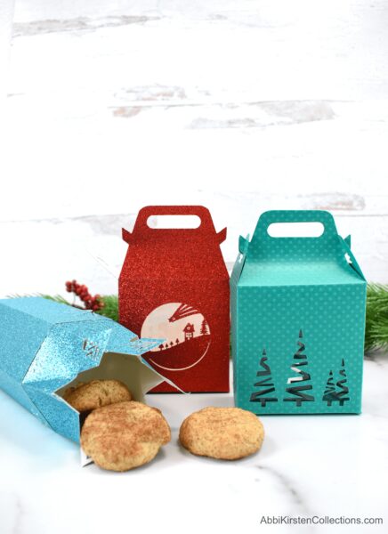 Three DIY cookie treat boxes made with Cricut in red, green and blue. A last minute Christmas gift to make with Cricut.