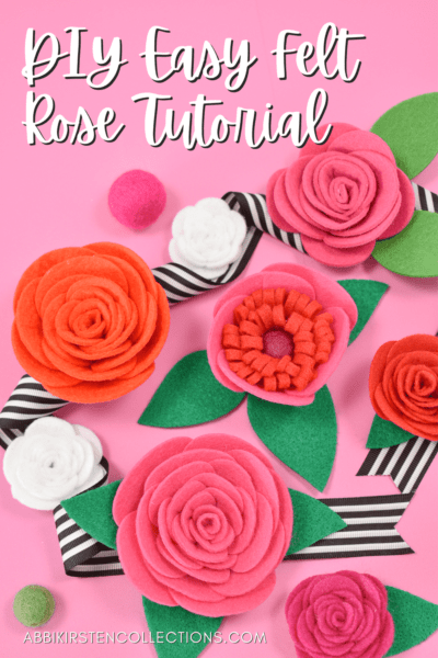 Red and pink felt roses with black and white striped ribbon and green felt leaves on a pink background. The text reads "DIY Easy Felt Rose Tutorial."