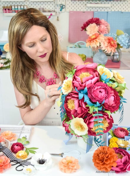 Abbi arranges a colorful paper flower bouquet in her craft room. Follow this flower tutorial to create your own blossom bouquet.