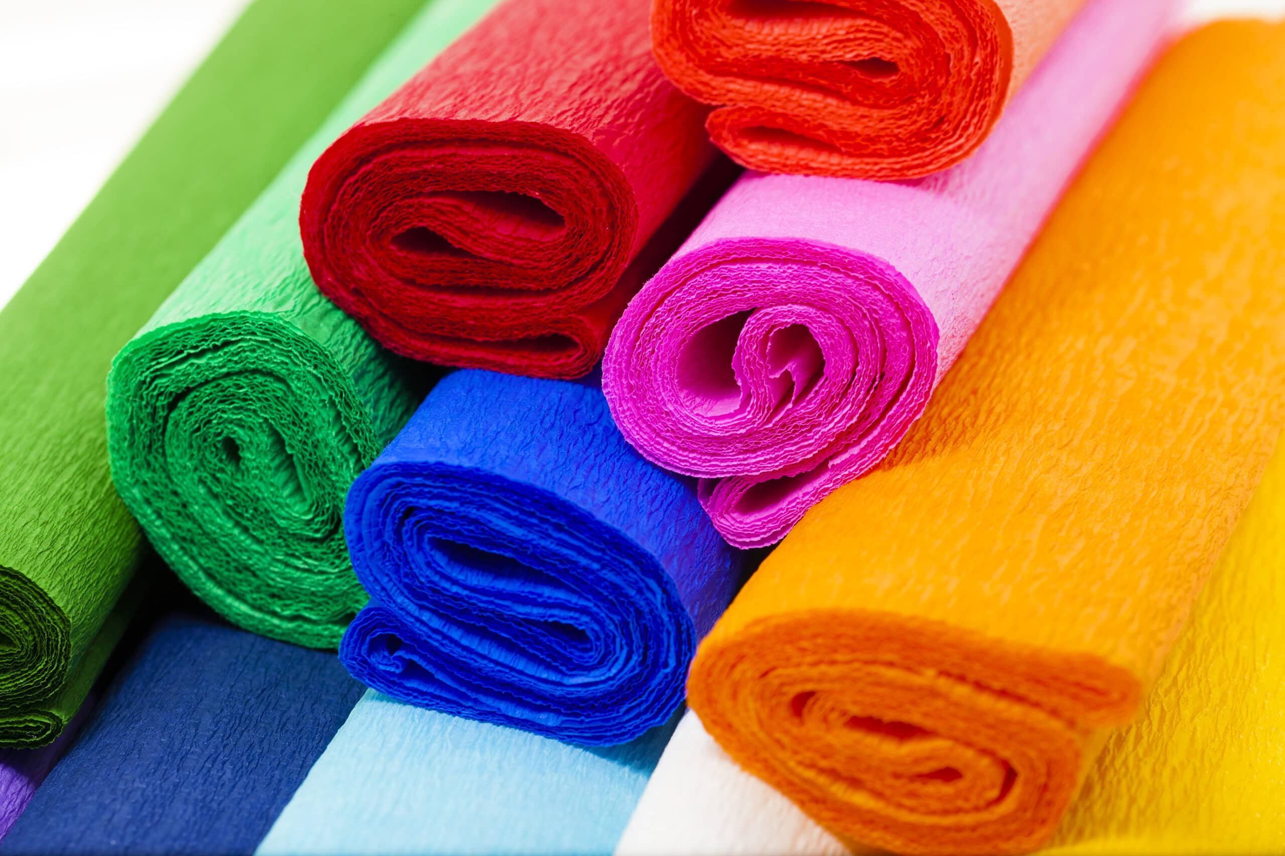 Rolls of crepe paper for making crepe paper flowers. You can make crepe paper flowers using red, orange, pink, green, and blue crepe paper in any colorful shade.