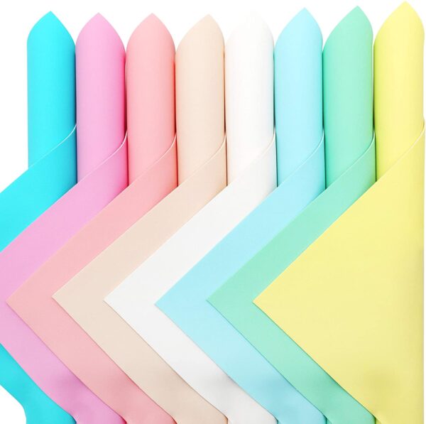 Rolled candy-colored faux leather sheets on a white background. 