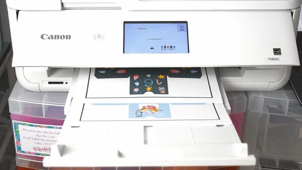 A Canon color printer is printing the DIY advent calendar boxes on white paper. You can use your Cricut to help with the Print then Cut feature. 