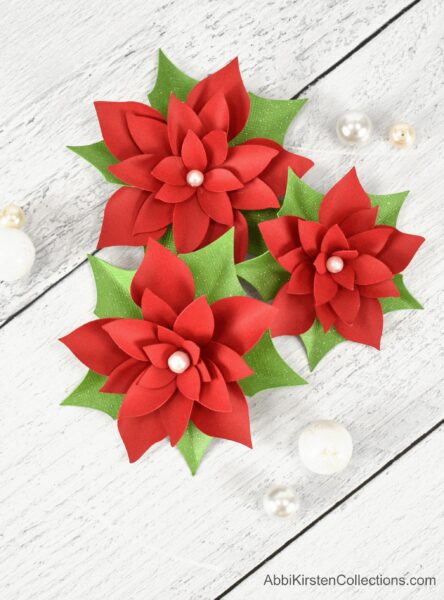 Small poinsettia paper flowers. Download poinsettia flower templates to create an easy paper craft for your Christmas holiday decor. 