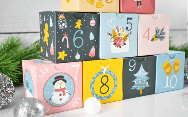 Among these stackable DIY Christmas advent calendar boxes are white and silver balls and garland. You can get these printable templates from AbbiKirstenCollections. 