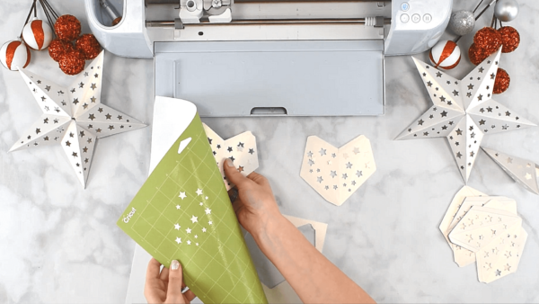 Abbi cutting star templates with Cricut. 