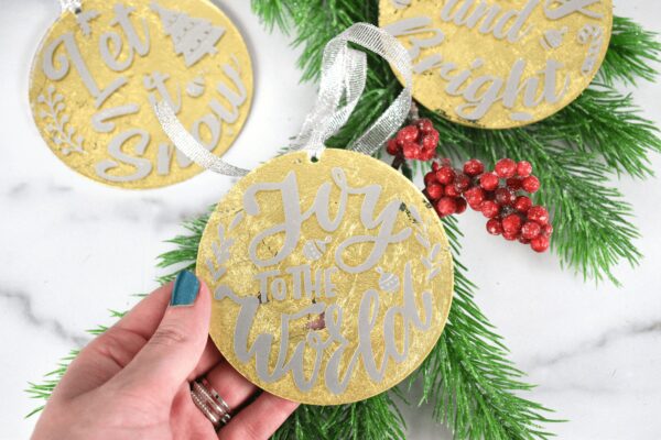 A set of three golf leaf acrylic Christmas ornaments, with festive Christmas saying applied in white vinyl.