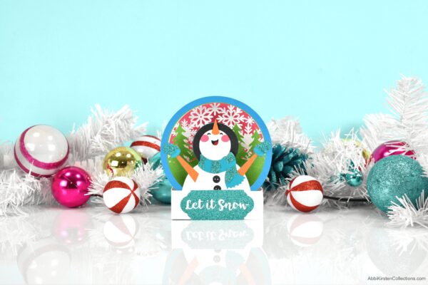 Snowman pop up Christmas card with blue background and ornaments