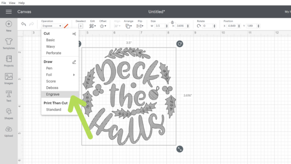 A screenshot of the design canvas in Cricut design space with a "deck the halls" SVG set up on the grid. A green arrow is pointing to a dropdown menu, indicating where to change the Design Space settings to engrave.
