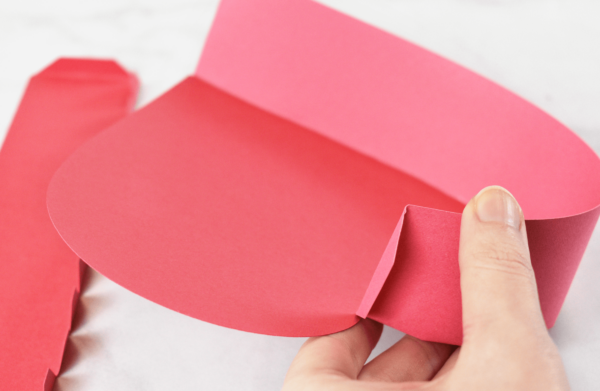 The sides being attached to a dark pink paper heart box. 