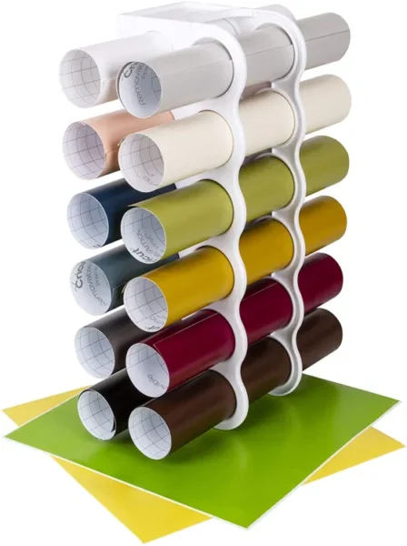Storing Cricut vinyl rolls in these wall-mounted storage shelves has been a lifer-saver craft storage solution! These vinyl holders are the perfect shape for tubes of vinyl.