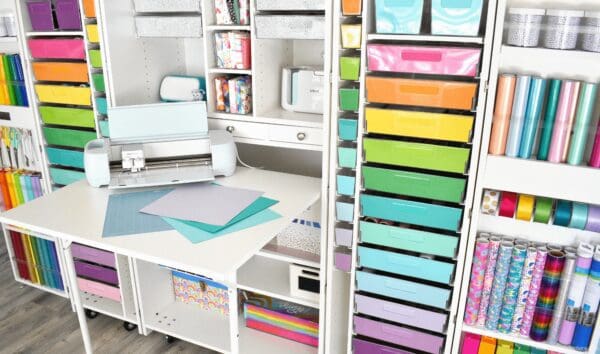 Cricut craft cutting machine on an open Dreambox table with rainbow colored totes. 