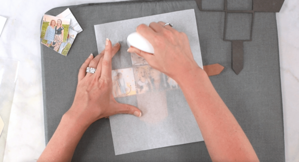 Photos being pressed onto a photo keychain holder with a white EasyPress Mini on a grey mat. 