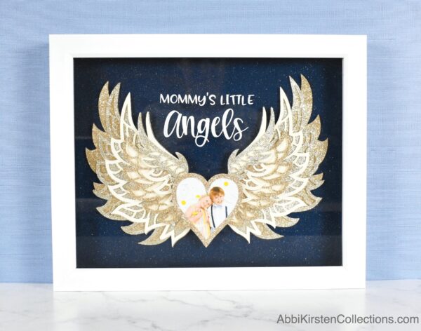 Layered angel wings mandala inside a shadow box with photo. 