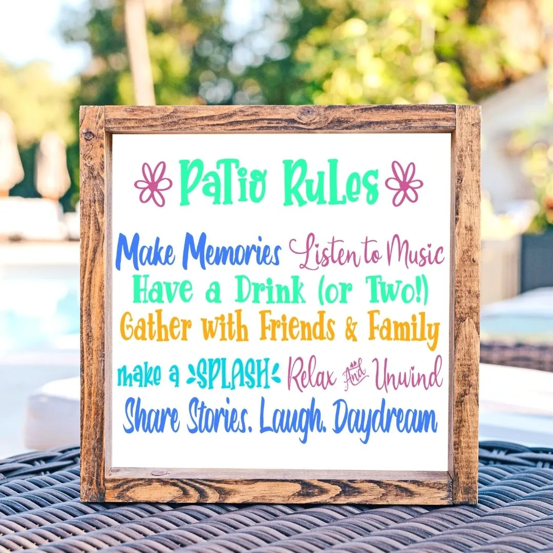 A white sandwich board has colorful patio rules written on the front.