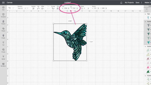 This Design Space canvas shows a blue and green illustrated hummingbird surrounded by a box. A pink arrow points from the square to the lock icon on the top menu. 