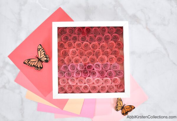 Pink ombre rolled paper flowers for a shadow box. 