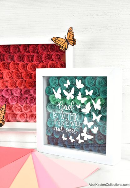 Create an easy DIY shadow box with rolled paper flowers and your Cricut. Learn the best way to apply vinyl to your shadow box and discover more cricut shadow box ideas!