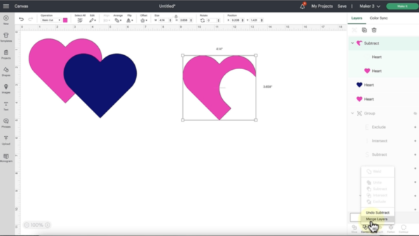 Cricut Design Space updates include merging layers. This is demonstrated on the canvas page, on which are a pink heart behind a blue heart, with a pink heart with a section missing from the design to the right. 