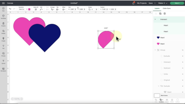 The pink heart behind the blue heart remains on the Cricut Design Space screenshot. There is also a piece of another pink heart. 