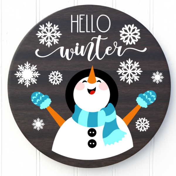 A circular sign that says "hello winter" with a snowman and snowflakes. 