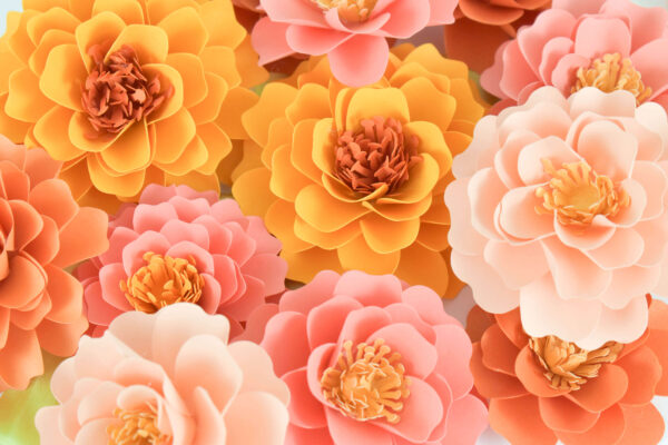 Paper marigolds are often associated with the Day of the Dead, or Dia de Los Muertos. Learn to capture the beauty of marigolds as DIY paper flowers. Download the marigold SVG cut files for cutting machines and PDF printables perfect for decorating for fall. 