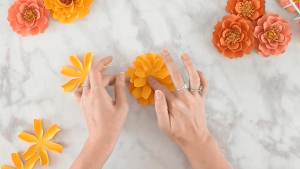 Crafting DIY paper marigold flowers. 