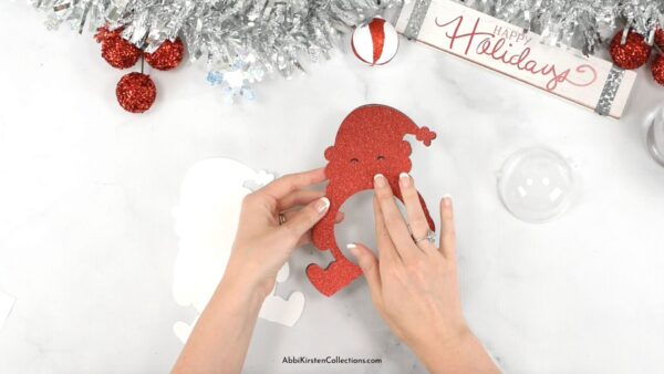 Gluing together the Santa Claus paper craft template. 