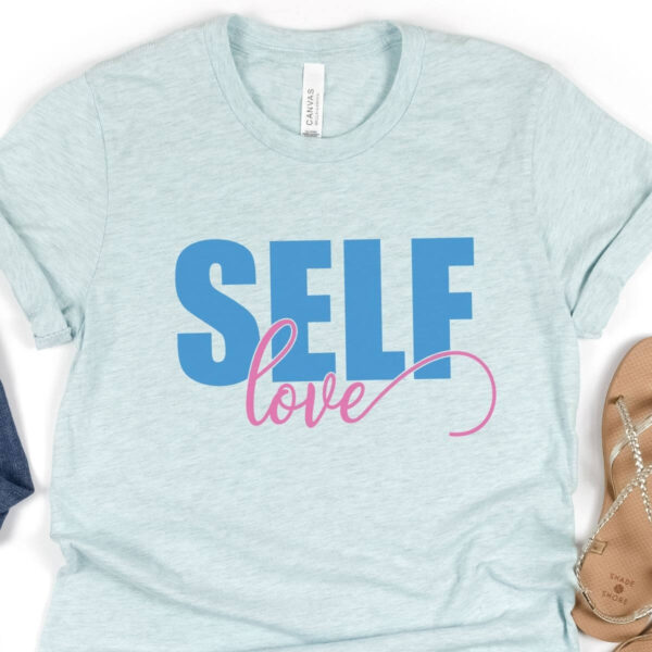 A light blue t-shirt has a graphic on it that reads "Self Love." This SVG file is free to use. 