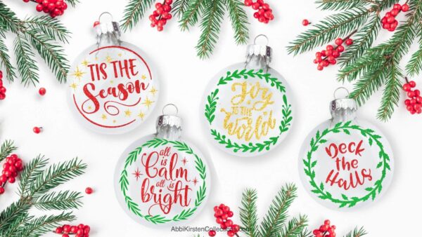 The image shows a set of four floating ornaments with christmas phrases inside such as Joy to the world, deck the halls, and tis the season. 