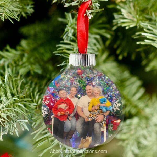 The image shows a floating photo Christmas ornament on a tree. Get the tutorial for making floating photo ornaments here. 