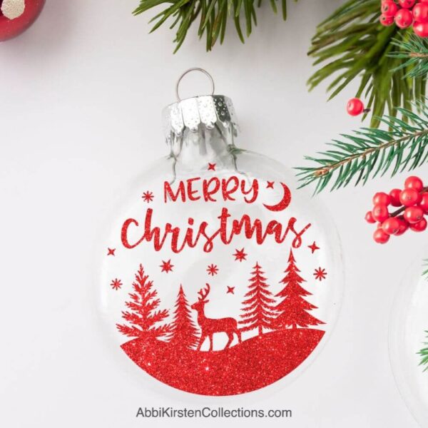 The image shows a floating ornament with red Merry Christmas deer design inside. 