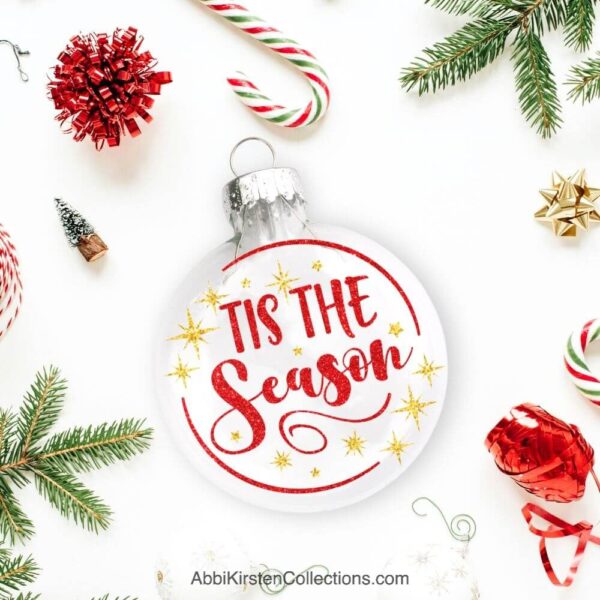 The image shows an ornament with the phrase Tis the Season. 
