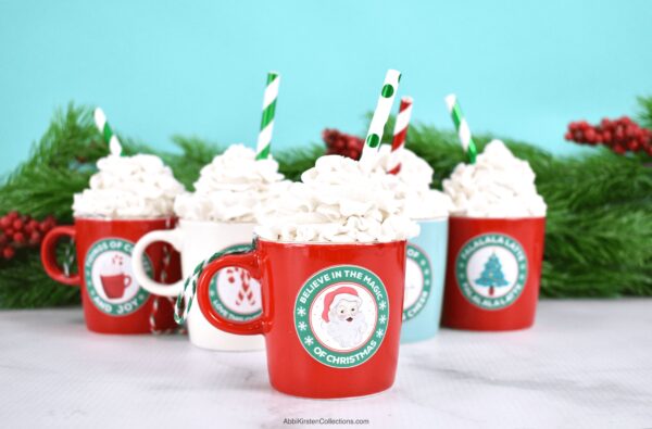 Five mini coffee cup ornaments with customized Christmas coffee label stickers. Get the free printable Christmas stickers at Abbi Kirsten Collections.