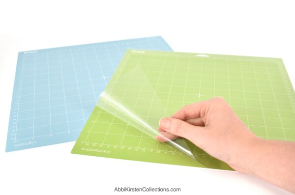 The image shows a green and blue Cricut mat and how to store them for best results. 