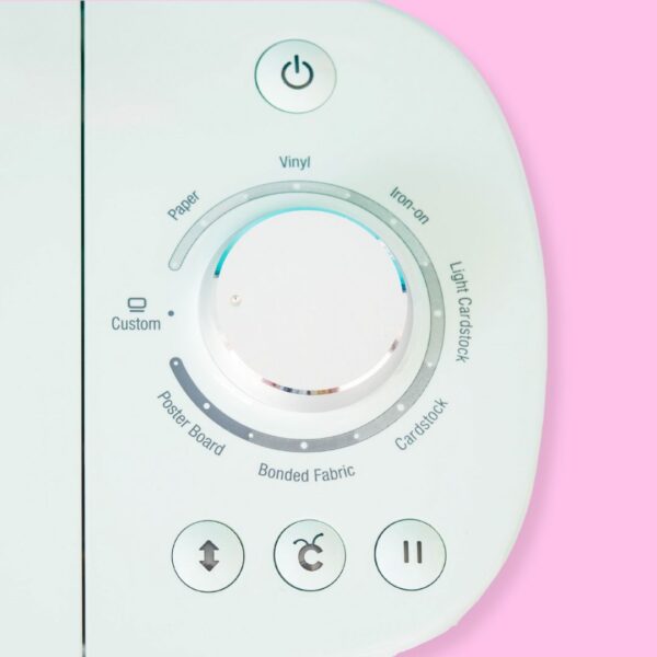 A close-up of the dial and buttons on a Cricut Explore Air 2 machine.