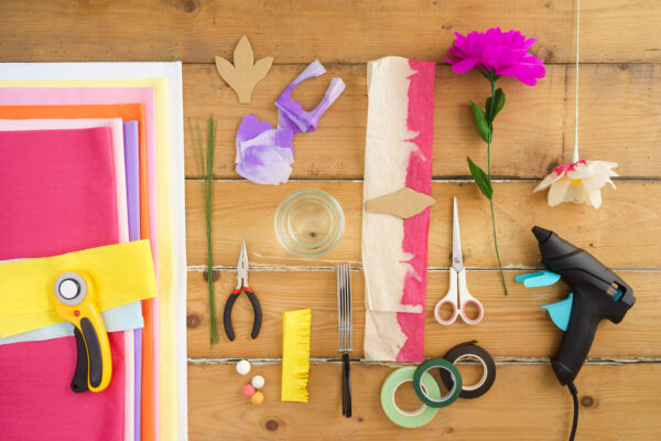 Craft desk that shows paper flower supplies and tools.