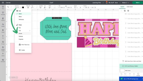 Different parts of a birthday card template are altered on the canvas of Design Space. A green arrow points to the "score" command. 
