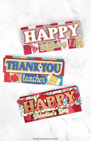 3D layered Cricut cards saying, "happy birthday," "Thank you teacher," and "Happy Valentine's Day."