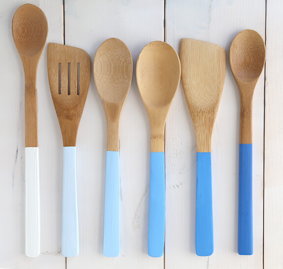 A set of wooden cooking utensils with its bases in different shades of blue