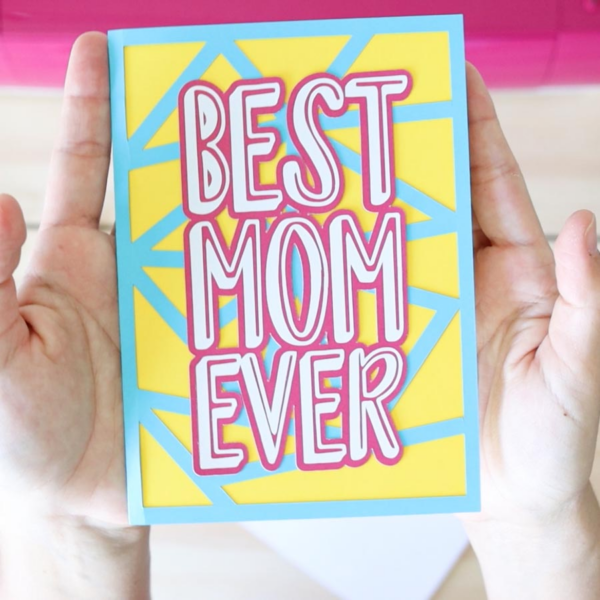 The image shows a card in blue and yellow that says, best mom ever. Get the free SVG file