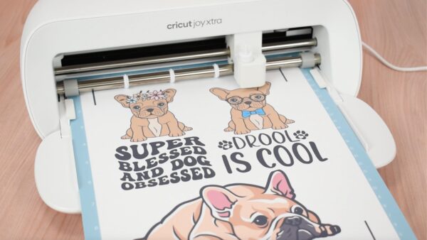 The Joy Xtra machine cutting out french bulldog puppy stickers.