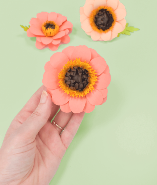 DIY Paper Zinnia flowers on green background. Find the template and tutorial on Abbi Kirsten Collections. 