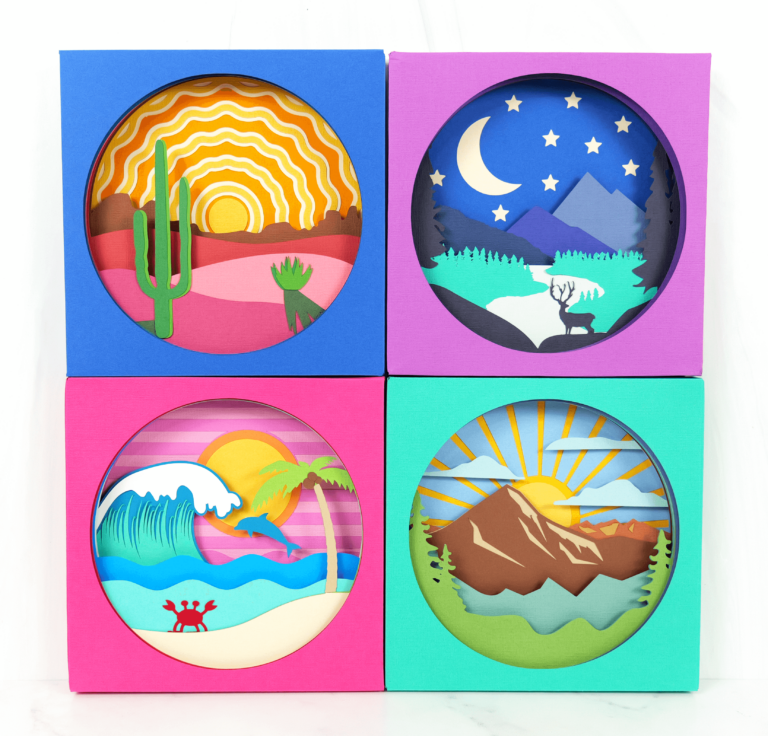 Set of 4 landscape shadow box scenes showing a beach, a mountain range, a mountain and river and a desert sunrise.